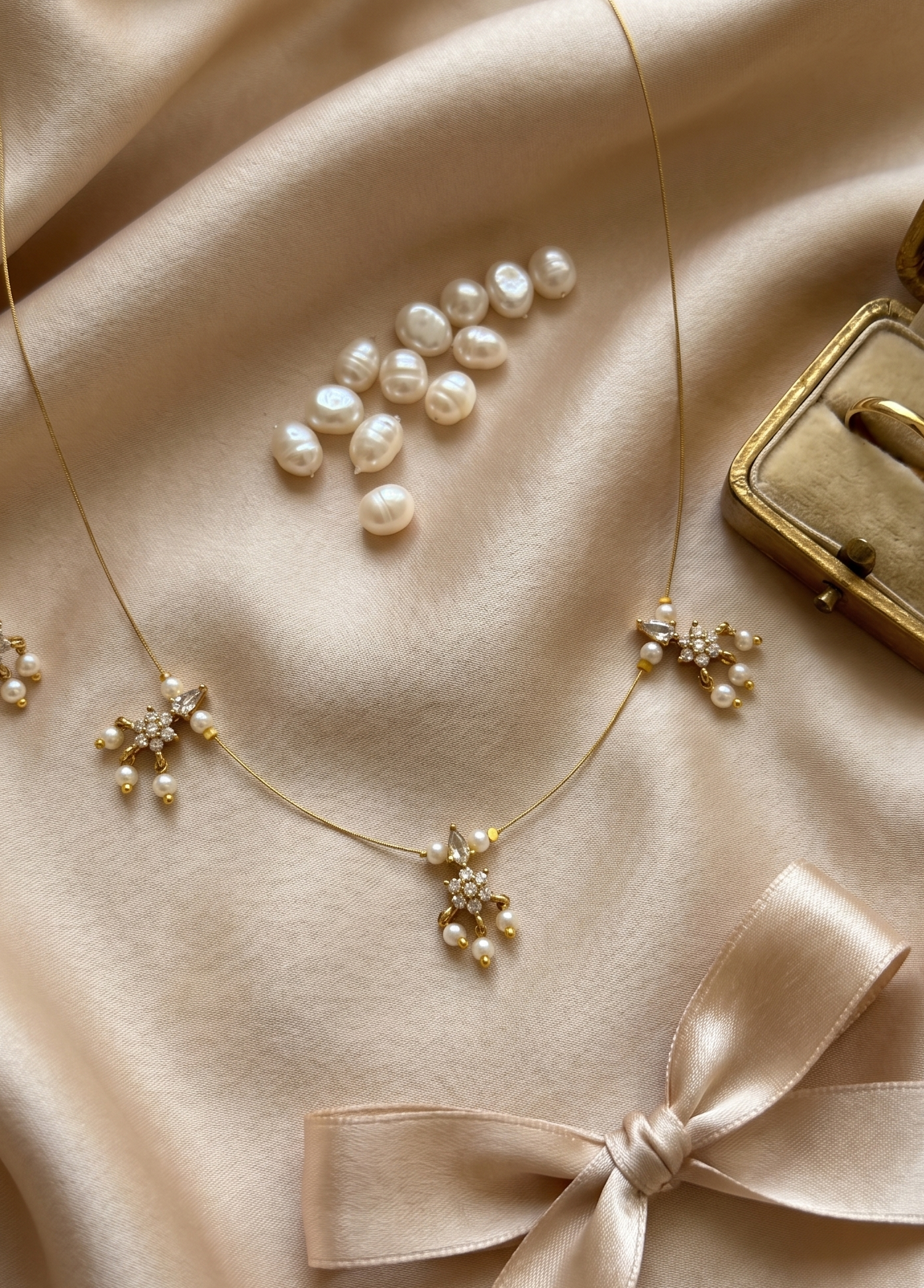 Elegant Invisible Chain necklace with Floral Motif and Pearl Accents