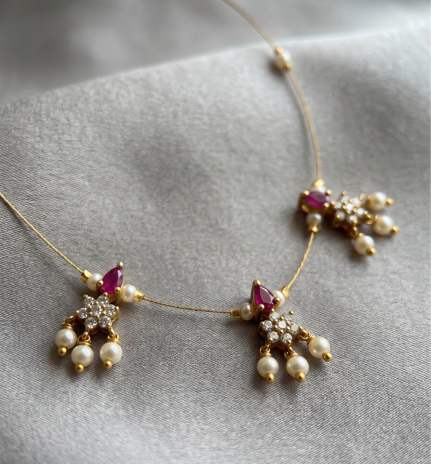 Elegant Invisible Chain necklace with Floral Motif and Pearl Accents