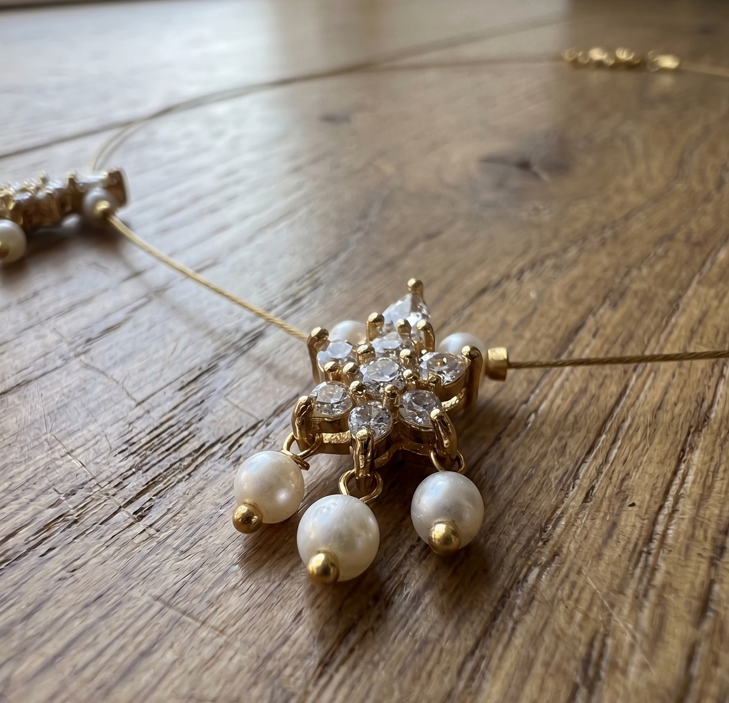 Elegant Invisible Chain necklace with Floral Motif and Pearl Accents